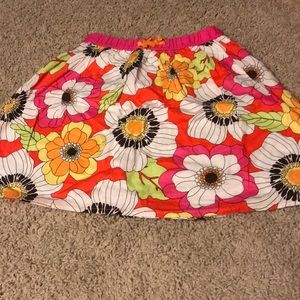 Colorful, flower patterned skirt.